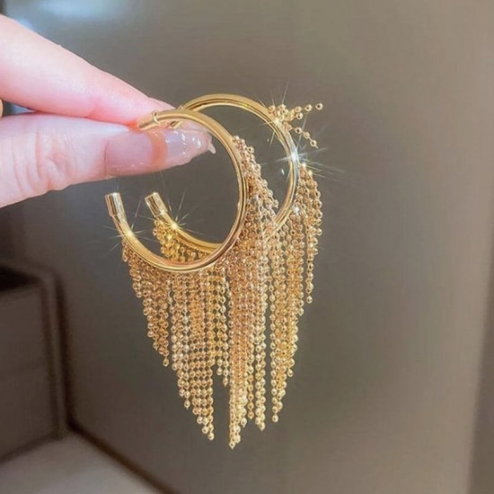 A close-up photo of a hand holding a pair of gold hoop earrings with delicate fringe chains. Fashion Tassel Design Hoop Earrings For Women|image