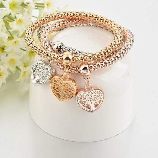 Three interconnected beaded bracelets in gold, silver, and rose gold tones, each with a dangling heart charm featuring a Tree of Life design.
