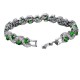 A beautiful silver bracelet with emerald green crystals and clear crystals set in a wavy pattern.