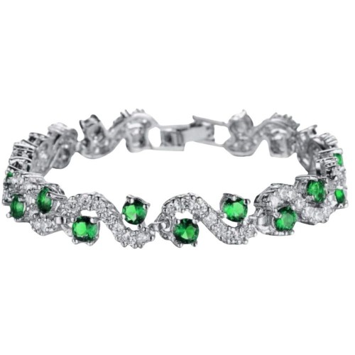 A beautiful silver bracelet with emerald green crystals and clear crystals set in a wavy pattern.
