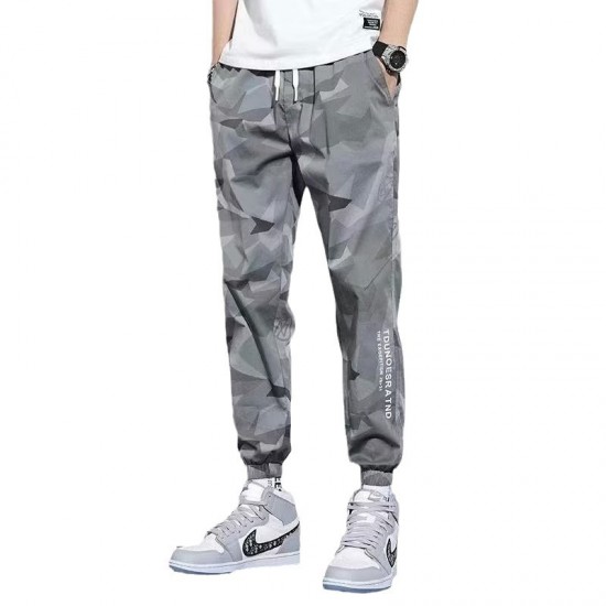 Men's wearing relaxed-fit camouflage sweatpants with multiple pockets, lounging comfortably in a UAE setting. Men's Camo Sweatpants With Multi Pockets-Grey |image